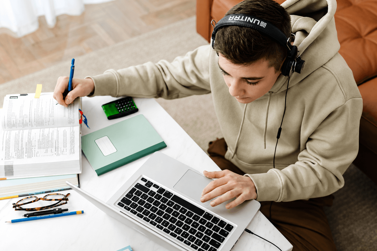 Student learning with laptop and study materials at Kryzotech